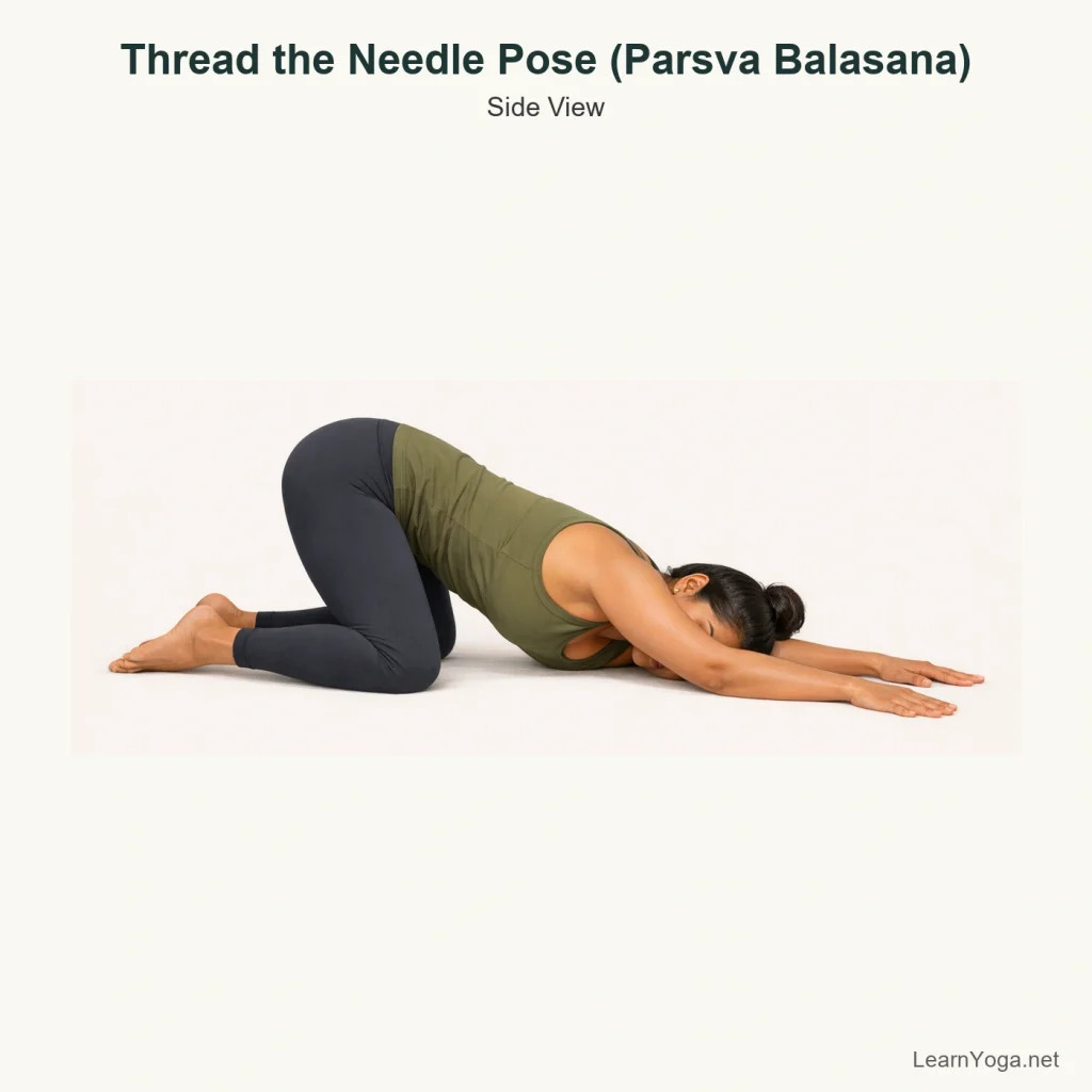 Side view of Thread the Needle Pose with one arm slid under the chest and shoulder resting on the floor.